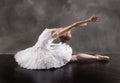 Ballerina in white tutu, leaning back like a swan