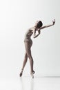 Ballerina. Young graceful female ballet dancer dancing isolated on white. Beauty of classic ballet. Royalty Free Stock Photo