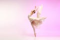 Ballerina. Young graceful female ballet dancer dancing over pink studio. Beauty of classic ballet. Royalty Free Stock Photo