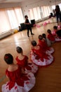 Ballerinas attending a ballet lesson.