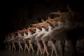 Ballerinas are in a row. The girls are lined up one after the other on the stage. Ballerinas in white tutus have their backs to