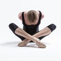 Ballerino Dancer Sitting While Practising Legs and Arms Stretching Exercices Before Training In Black Sportive Tights in Studio