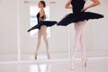 Ballet art performance dancer dancing, training and doing a balance on her feet with pointe shoes in an arts studio hall Royalty Free Stock Photo