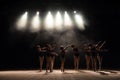 Ballet class on the stage of the theater with light and smoke. Children are engaged in classical exercise on stage
