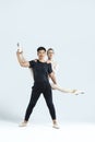 Ballet Concepts. Asian Young Man and Caucasian Woman Performing As Ballet Dancers Over Grey in Studio During Suppots As Classical Royalty Free Stock Photo