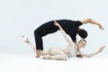 Ballet Concepts. Asian Young Man and Caucasian Woman Performing As Ballet Dancers Over Grey Studio Background Doing Suppots As Royalty Free Stock Photo