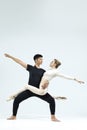 Ballet Concepts. Asian Young Man and Caucasian Woman Performing As Ballet Dancers Over Grey Studio Background Doing Suppots As Royalty Free Stock Photo