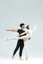 Ballet Concepts. Asian Young Man and Caucasian Woman Performing As Ballet Dancers Over Grey Studio Background Doing Suppots As Royalty Free Stock Photo