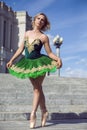 Ballet and Dance Concepts. Happy Smiling Professional Caucasian Ballet Dancer in Green Tutu Dress Posing in Dance On Stairs