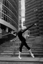 Ballet dancer on city street background. Artistic. Black and white.