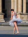 Ballet dancer dancing in front of the famous Louvre Museum