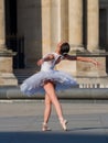 Ballet dancer dancing in front of the famous Louvre Museum