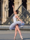 Ballet dancer dancing in front of the famous Louvre Museum