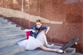 Ballet dancer hipster sitting on the stairs. Royalty Free Stock Photo