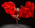 Ballet Dancer jumping with Red Silk Fabric flying on Wind over Black Background. Beautiful Ballerina dancing in waving Dress with Royalty Free Stock Photo