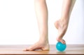 Ballet dancer massage the forefoot with a ball Royalty Free Stock Photo