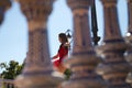 Ballet dancer in red tutu dancing in the street. The ballerina is doing different ballet postures and movements. Classical ballet