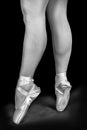 A ballet dancer standing on toes while dancing artistic conversion