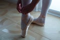 Ballet dancer tying ballet shoes. close-up. Royalty Free Stock Photo