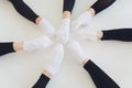 Ballet dancer tying ballet shoes. Close up ballet girl putting on her pointe shoes sitting on the floor, blurred Royalty Free Stock Photo