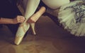 Ballet dancer tying ballet shoes. close-up. Royalty Free Stock Photo