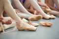Ballet dancer tying ballet shoes. Royalty Free Stock Photo
