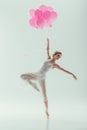 ballet dancer in white dress dancing with pink balloons Royalty Free Stock Photo