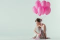 ballet dancer in white dress sitting with pink balloons Royalty Free Stock Photo