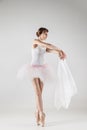 Ballet dancer in white tutu posing