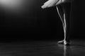 Ballet dancer& x27;s legs in pointe shoes on theater stage. Ballerina standing in 3 third position on black and white Royalty Free Stock Photo