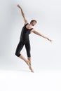 Ballet Dancer Young Athletic Man in Black Suit Posing in Ballanced Stretching Dance Pose Studio On White