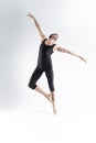 Ballet Dancer Young Athletic Man in Black Suit Posing in Stretching Dance Pose Studio On White Royalty Free Stock Photo