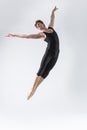 Ballet Dancer Young Man in Black Dance Suit Posing in Flying Ballanced Dance Pose Studio On White