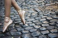 ballet dancers feet in pointe shoes on cobblestone street Royalty Free Stock Photo