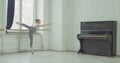 Ballet dancers practicing adagio in rehearsal room