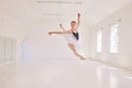 Ballet dancing and jumping practicing in a dance studio or class preparing for a performance. Young elegant dancer