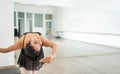 ballet female dancer stretching and warming up before a presentation. Young ballerina showing and demonstrating flexibility and Royalty Free Stock Photo