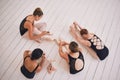 Ballet, fitness and stretching ballerina dancer group on floor, getting ready for rehearsal in dance studio. Above Royalty Free Stock Photo