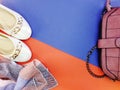 Ballet flat lady shoes and purple bag on red and blue background Royalty Free Stock Photo