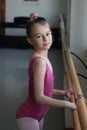 Ballet girl standing next to the barre