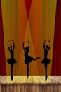 Ballet girls silhouettes of dancing ballerinas on stage in the spotlight with a red curtain background