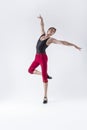 Ballet Ideas. Contemporary Ballet of Flexible Athletic Man Posing in Red Tights in Dance Pose With Hands Lifted in Studio on White