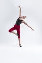 Ballet Ideas. Modern Ballet of Flexible Athletic Man Posing in Red Tights in Ballanced Dance Pose With Hands Lifted in Studio on