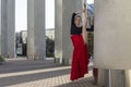 Ballet Ideas. Professional Ballet Dancer in Red Tutu Dress Posing in Red Skirt in Stretching Dance Pose With Lifted Hands and