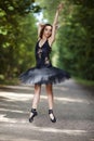 Ballet Ideas. Young Professional Japanese Female Ballet Dancer in Black Tutu Demonstrating Ballet Pas in Summer Forest With