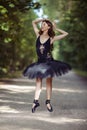 Ballet Ideas. Young Professional Japanese Female Ballet Dancer in Black Tutu Demonstrating Ballet Pas in Summer Forest With