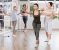 Ballet lesson for amateurs - choreographer teaches women of different ages different ballet steps in studio