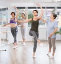 Ballet lesson for amateurs - choreographer teaches women of different ages different ballet steps in studio