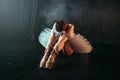 Ballet performer sits on floor, body flexibility