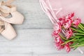 ballet, pointe shoes, tutu and bouquet of flowers on wooden background Royalty Free Stock Photo